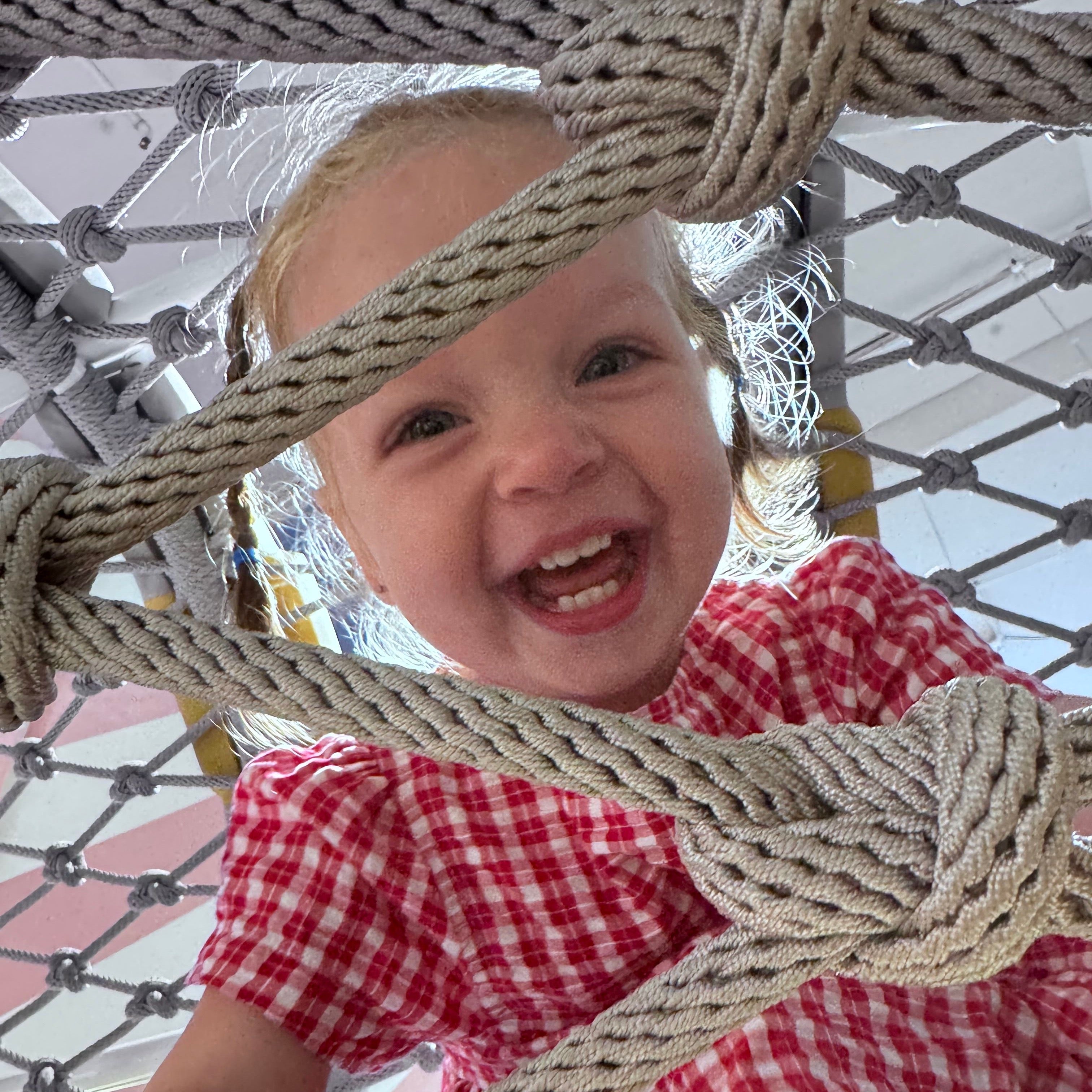 Isabel wearing Poppy Dress in Ruby Check. Age 12-18m • Wearing 6-12m