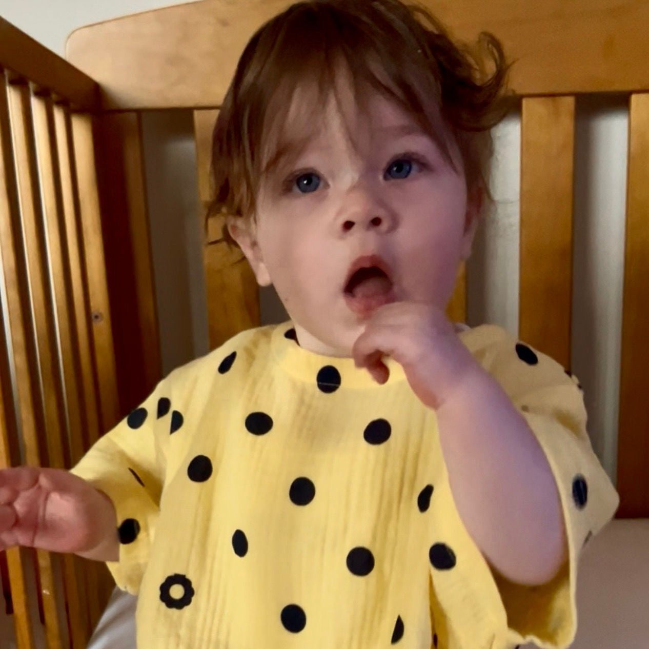 Vivi wearing Vivi Romper in Butter Dot. Age 6-12m • Wearing 6-12m