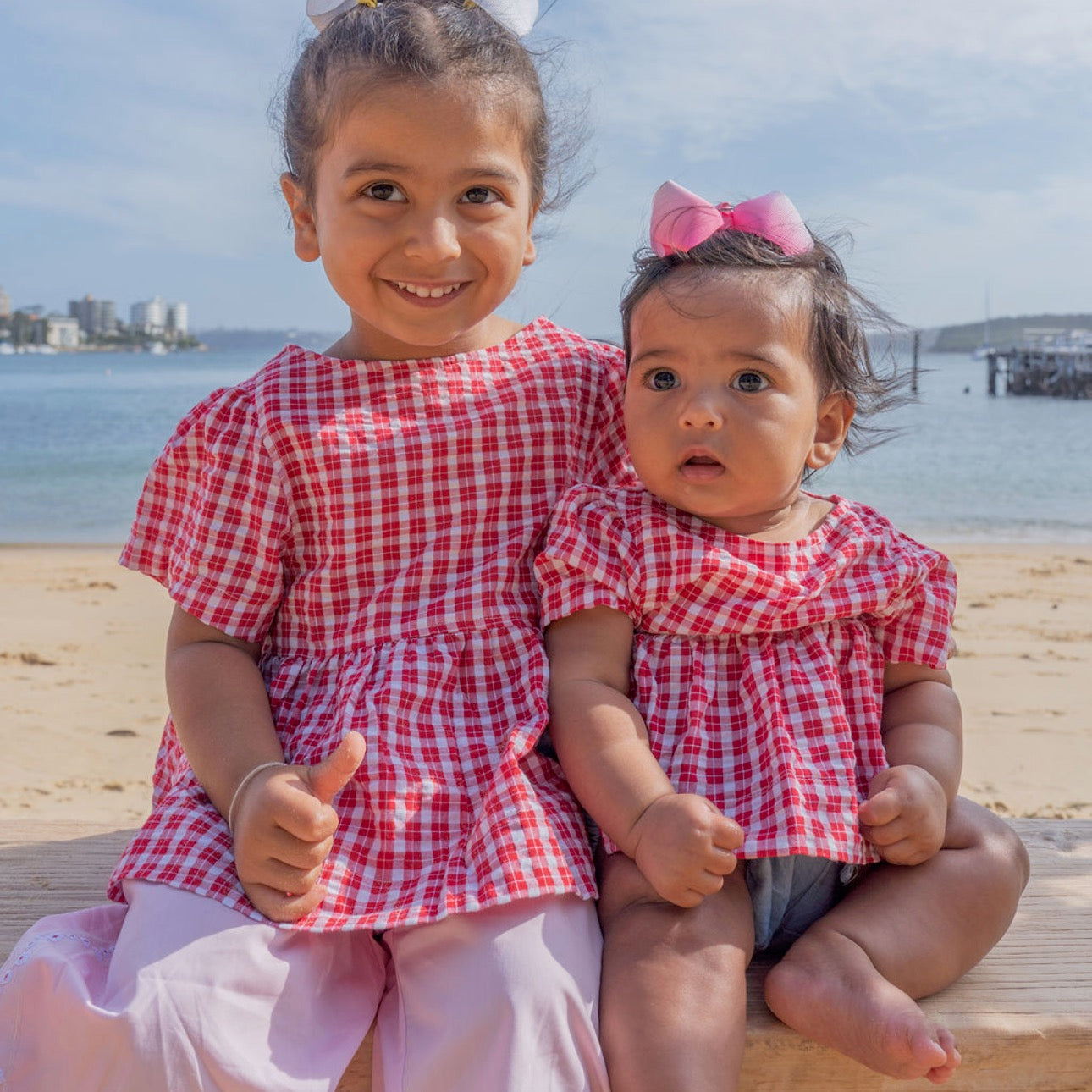 Dasha wearing Poppy Top in Ruby Check. Age 3 • Wearing 2-3Y