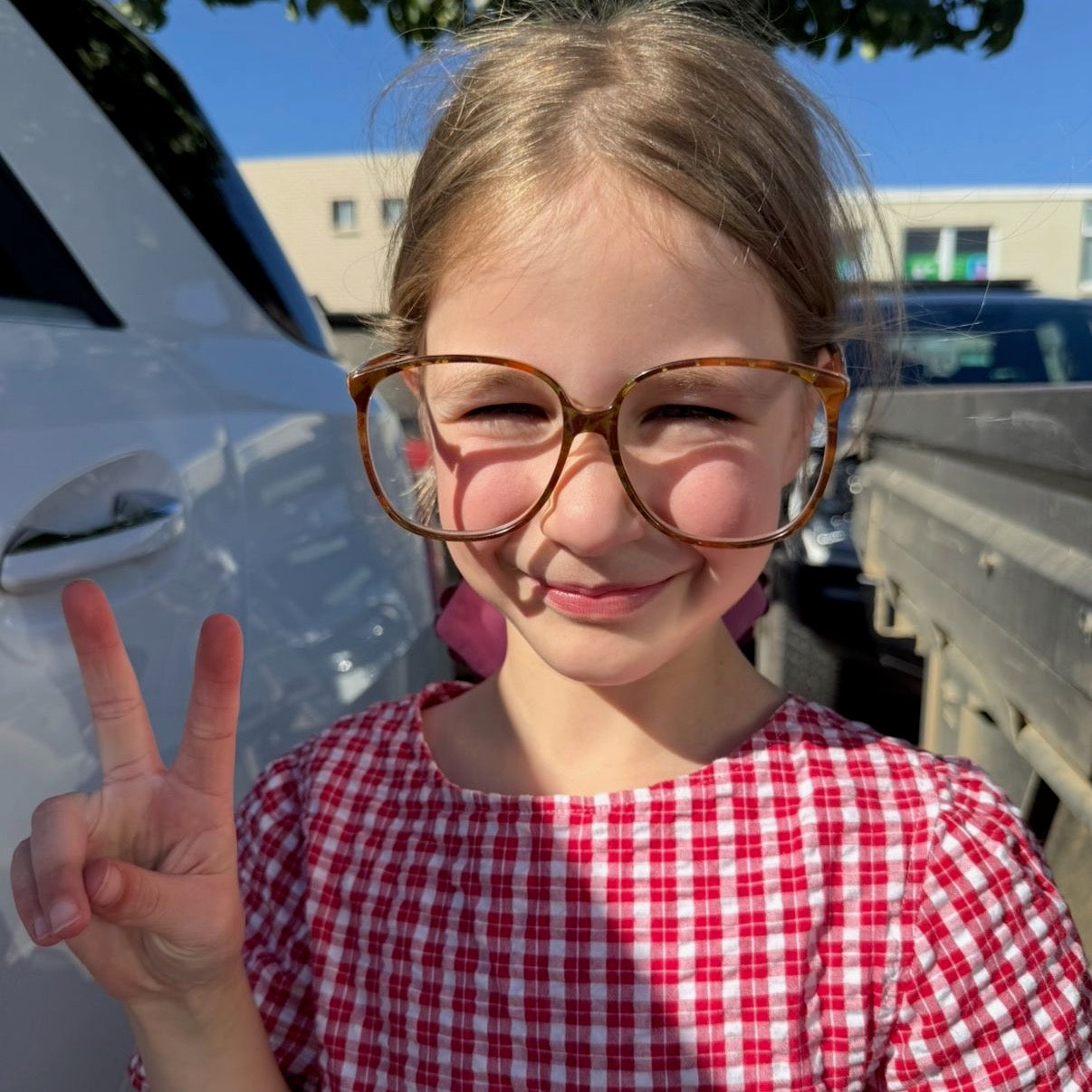 Peaches wearing Poppy Top in Ruby Check. Age 8 • Wearing 6-8Y