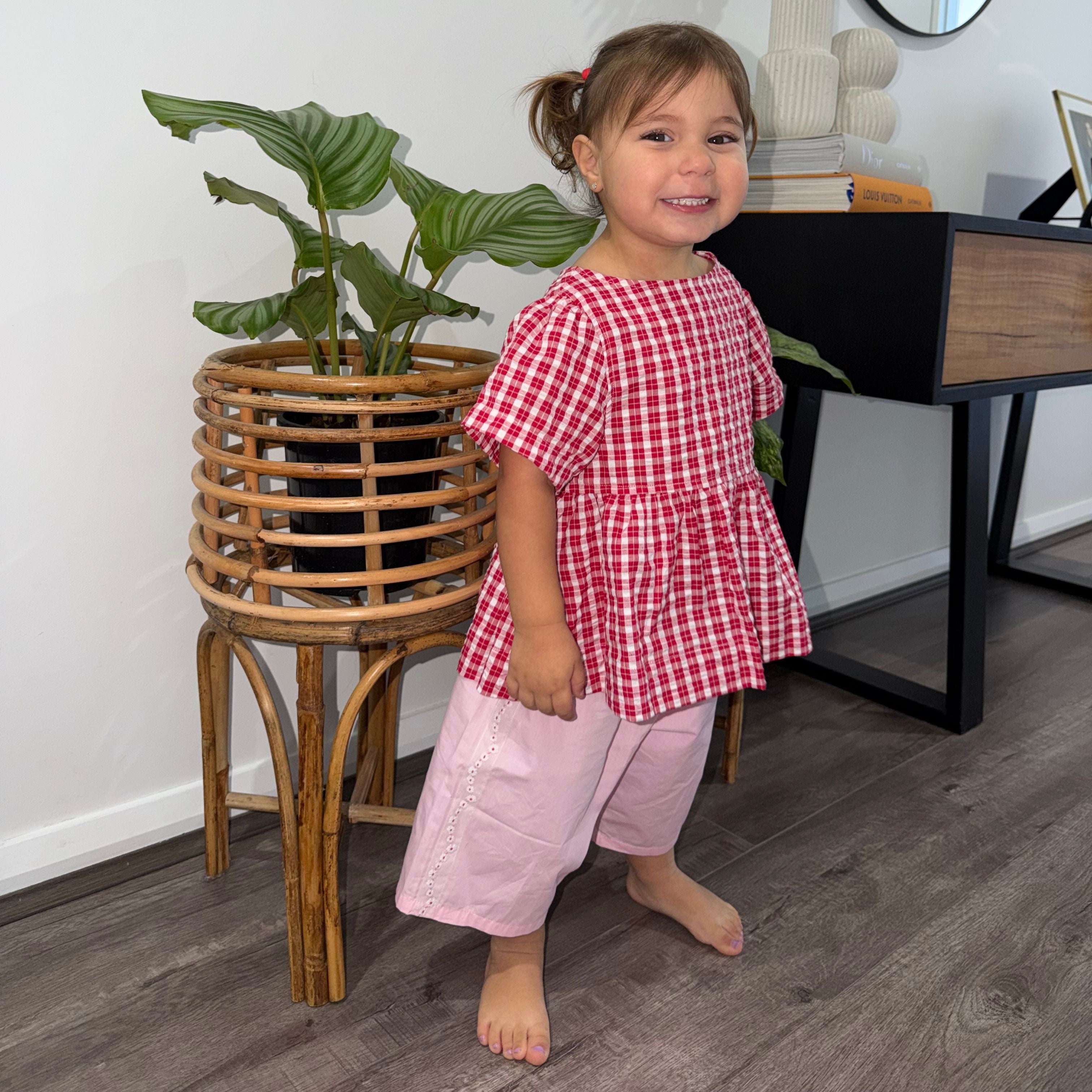 Hazel wearing Poppy Top in Ruby Check. Age 2 • Wearing 2-3Y