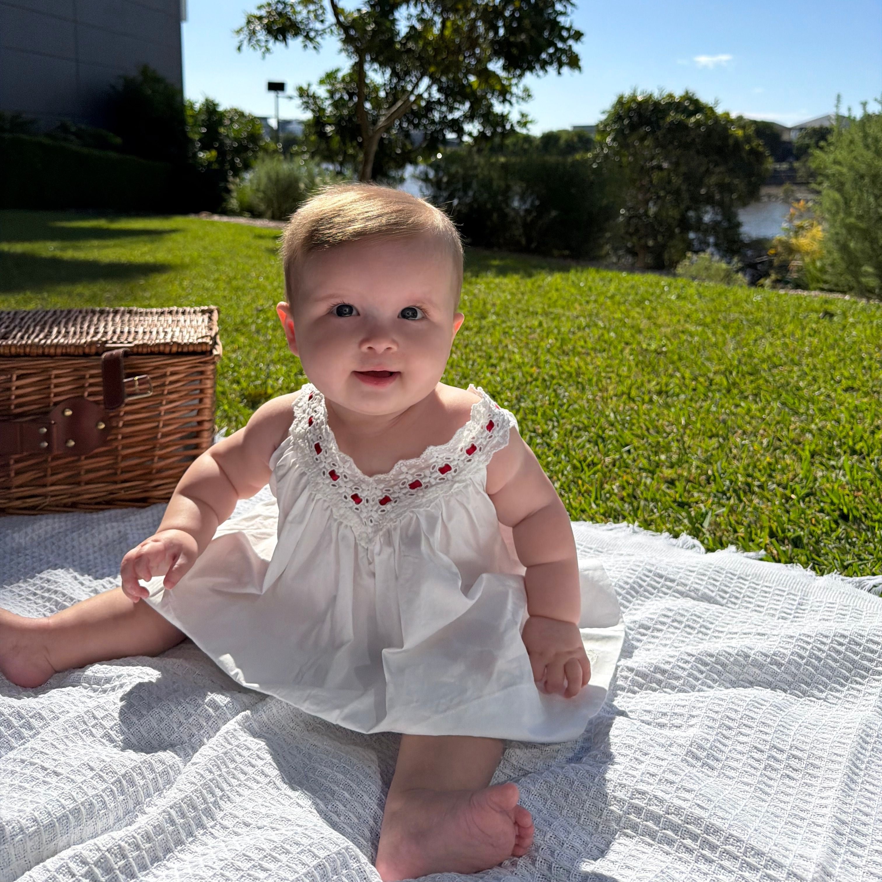 Alaya wearing Polly Dress in Coconut. Age 6-12m • Wearing 6-12m
