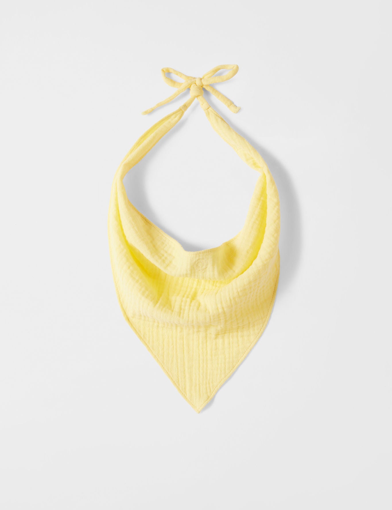 Yellow halter top on a light gray background