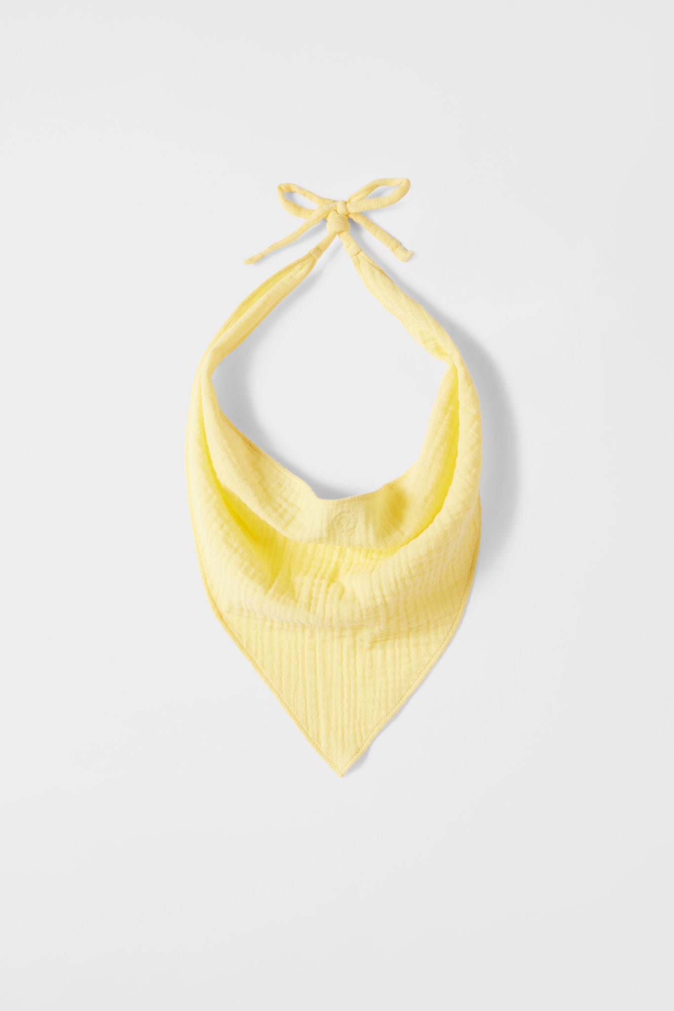 Yellow halter top on a light gray background