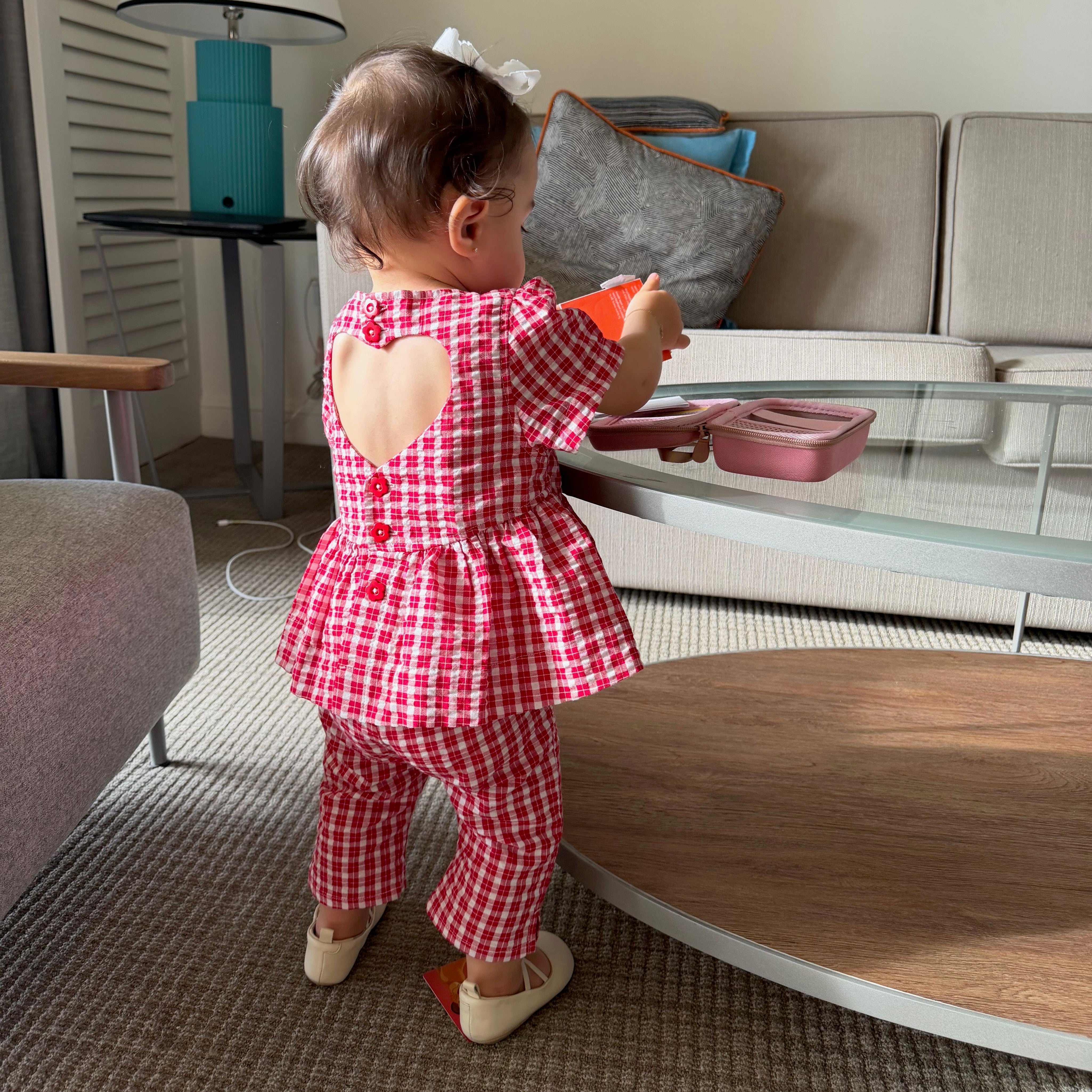 Emi wearing Poppy Top in Ruby Check. Age 12-18m • Wearing 12-18m