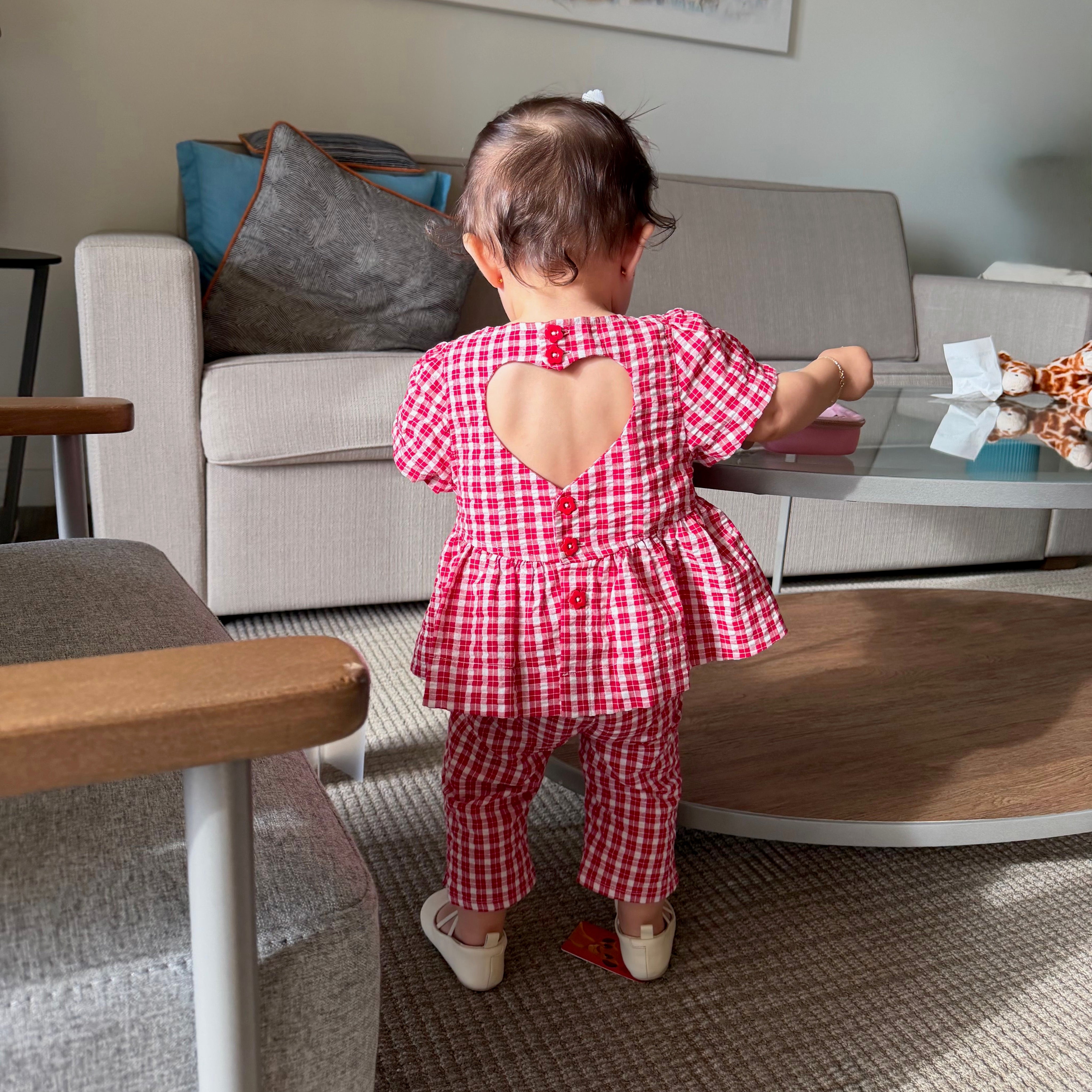 Emi wearing Poppy Capri in Ruby Check. Age 12-18m • Wearing 12-18m