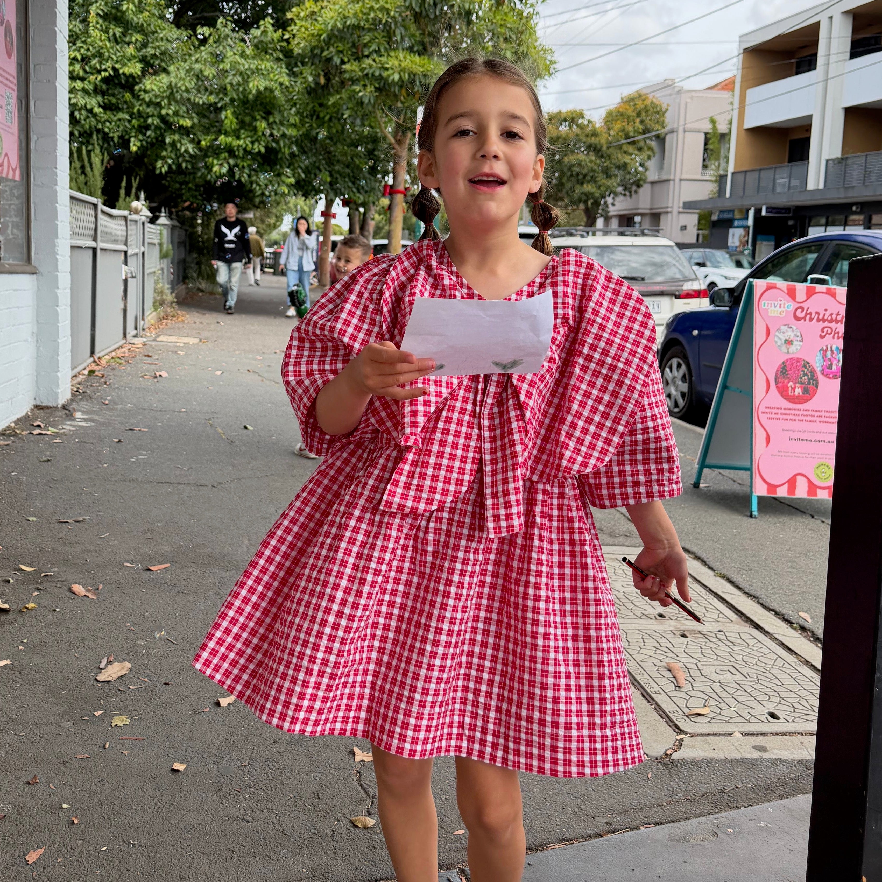 Penelope &amp; Killia wearing Poppy Dress in Ruby Check. Age 6 • Wearing 6-8Y