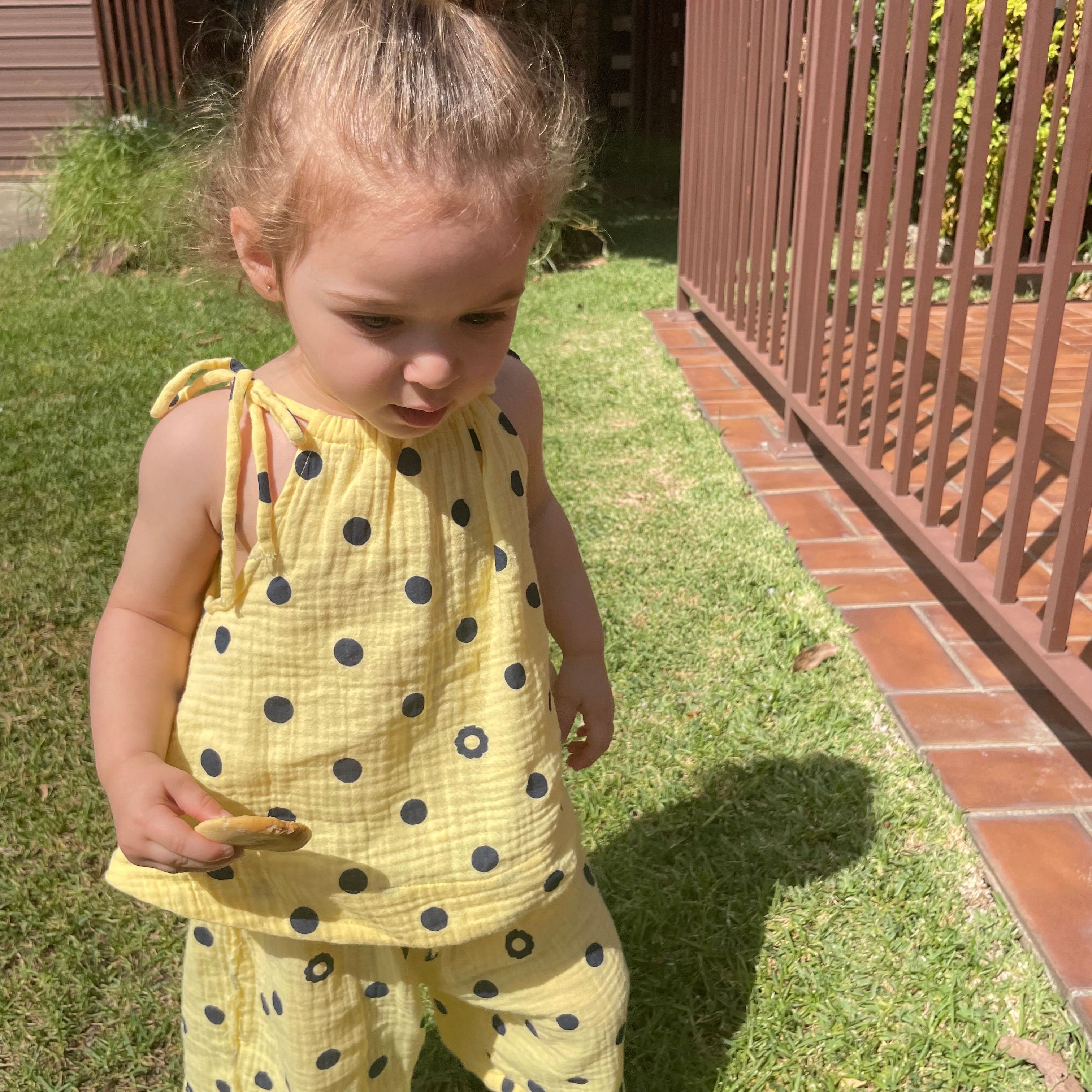 Amani wearing Lyra Lace Up Tank in Butter Dot. Age 2 • Wearing 2-3Y
